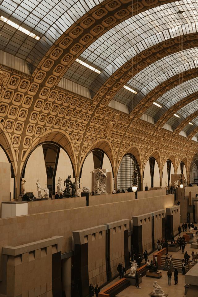 Explore the grand architecture of the Musée d'Orsay in Paris with its vaulted ceilings and historic charm.